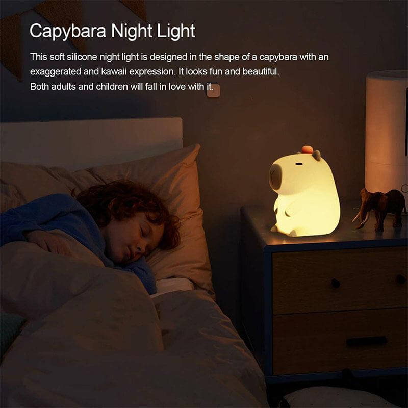 A child sleeping peacefully in bed with the UNEEJOY Capybara Night Light on the bedside table.