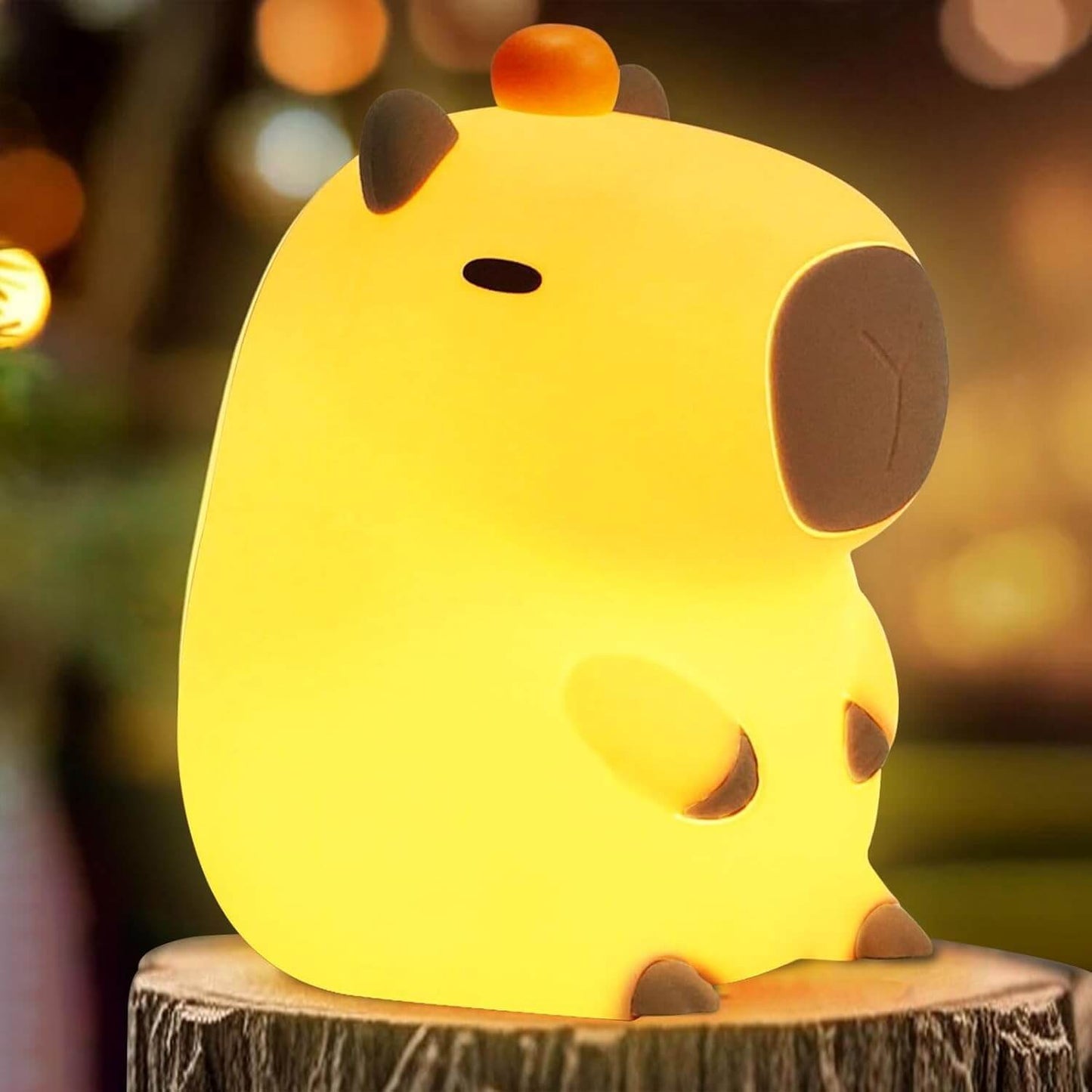 UNEEJOY cute capybara night light glowing warmly on a wooden pedestal.